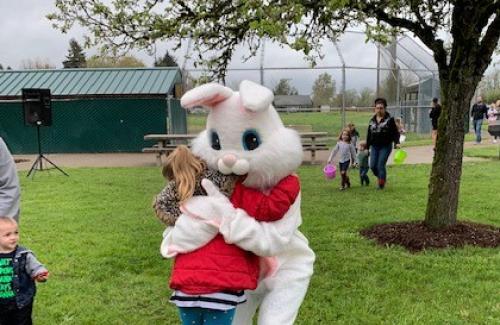 child hugs easter bunny