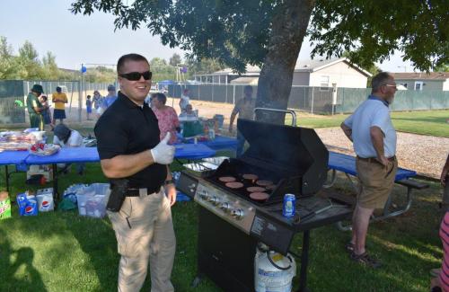 officer grilling food at national night out