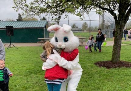 child hugs easter bunny