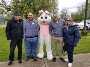 easter bunny stands with mayor and two city councilors